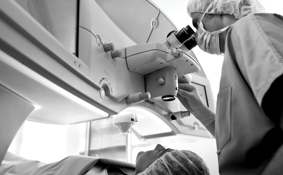 Surgeon at an excimer laser microscope